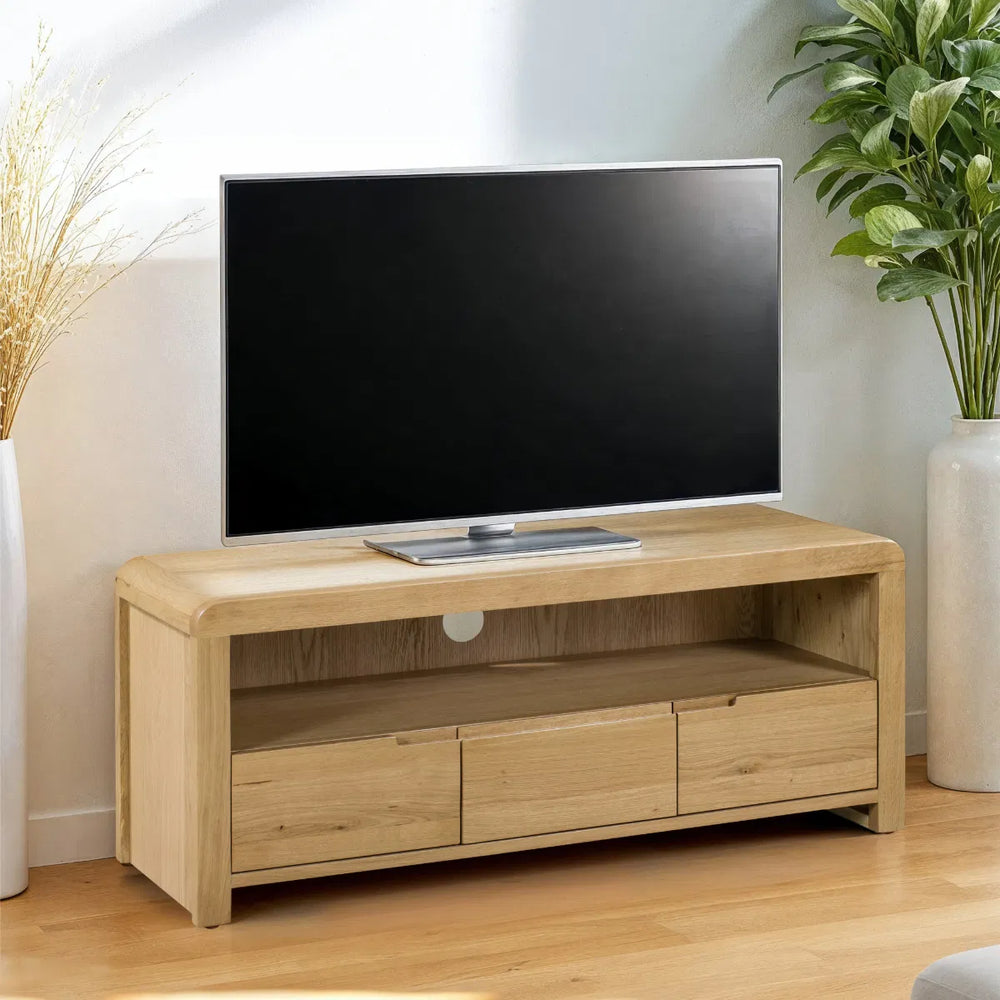 Wooden TV stand with drawers on a white background