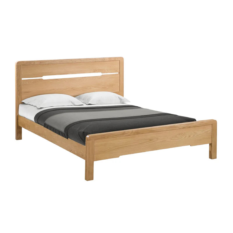 Wooden bed frame with bedding on a white background