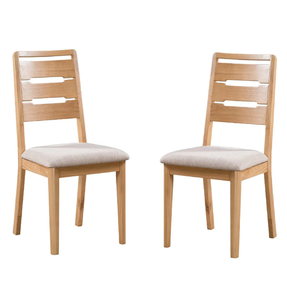 Two wooden chairs with beige cushioned seats on a white background