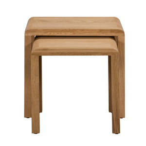 Two wooden nesting tables on a white background