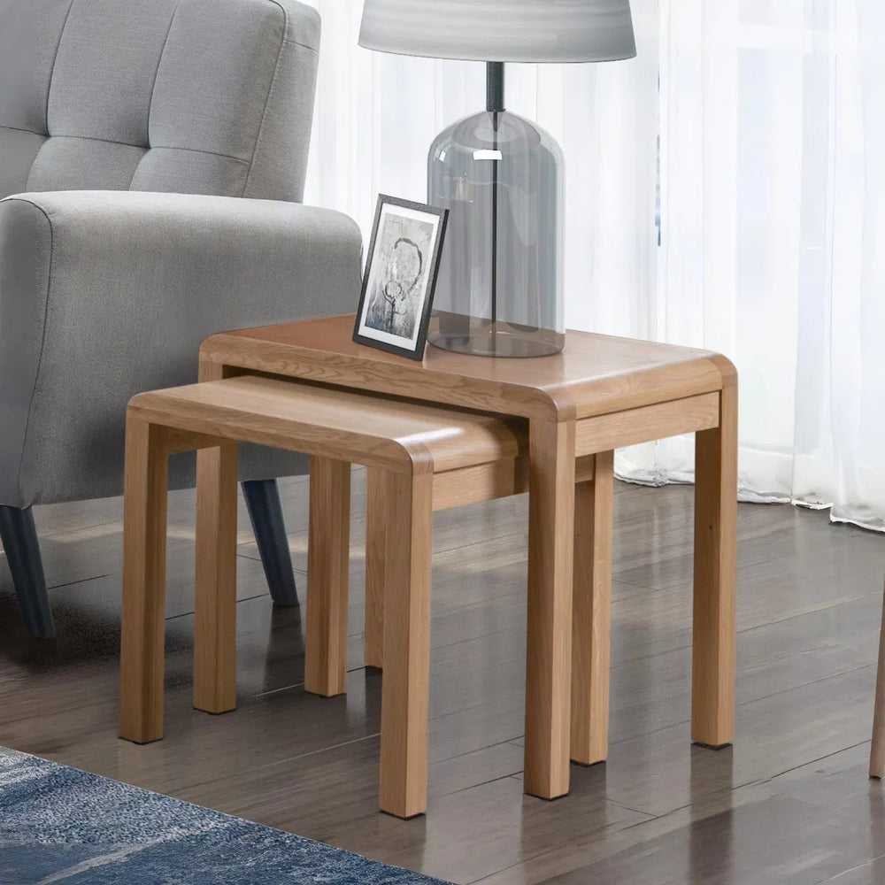 Set of two wooden nesting tables on a white background