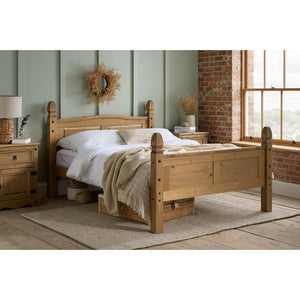 Wooden bed in a bedroom with a window and decorative elements.