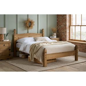 Wooden bed in a bedroom with a window and decorative elements.