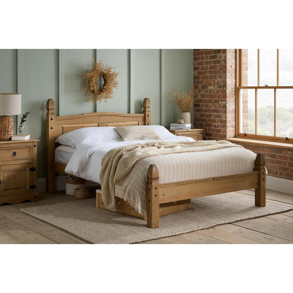 Wooden bed in a bedroom with a window and decorative elements.