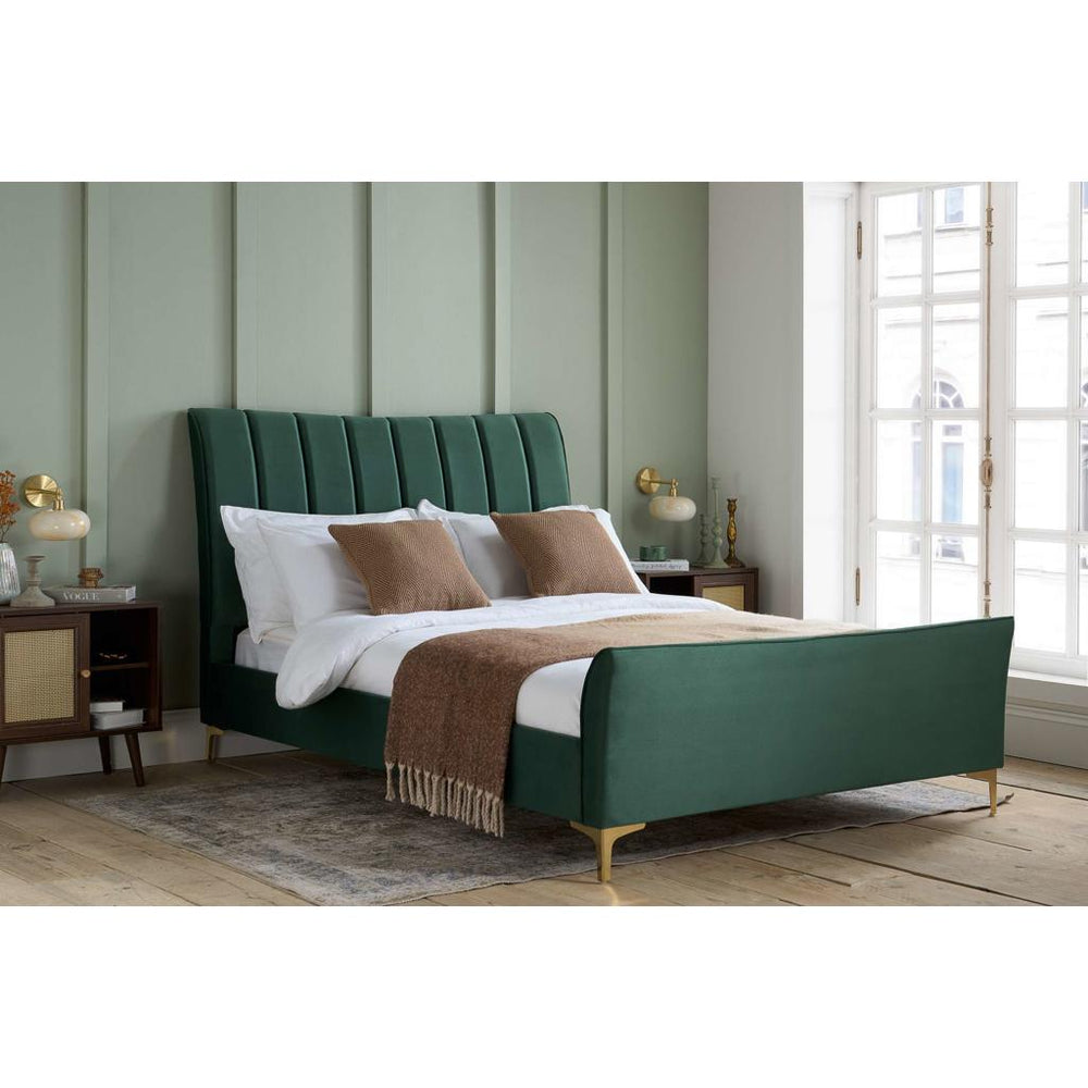 Black upholstered bed with white bedding on a white background