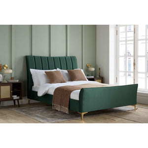 Green upholstered bed in a bedroom with neutral decor