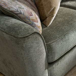Gray sofa with patterned cushions on a carpeted floor