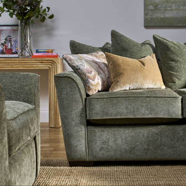 Gray sofa with patterned cushions in a living room setting.