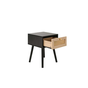 Black side table with a wooden drawer on a white background