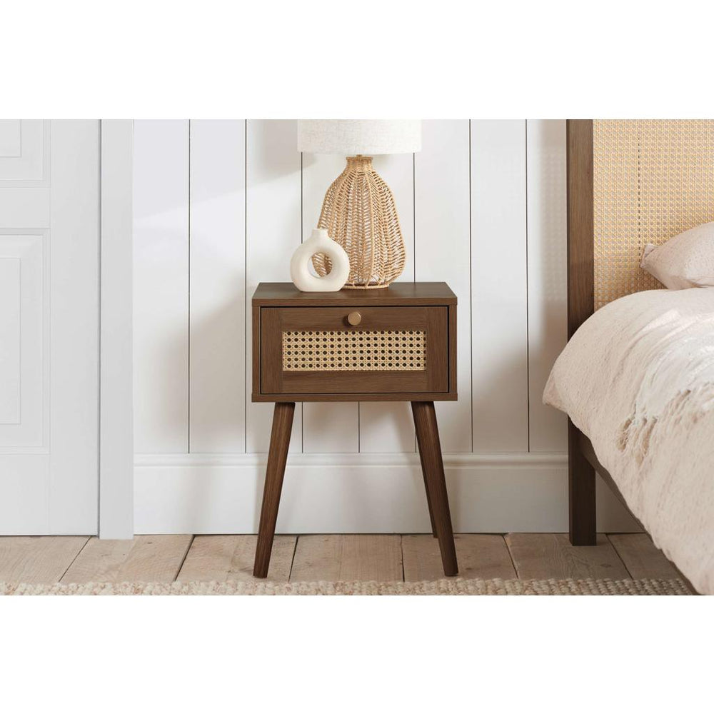 Wooden side table with a woven drawer on a white background