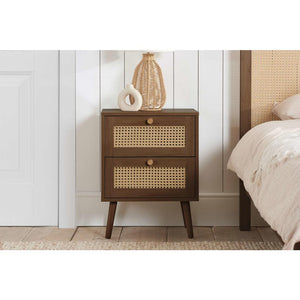 Wooden nightstand with woven design next to a bed in a bedroom setting