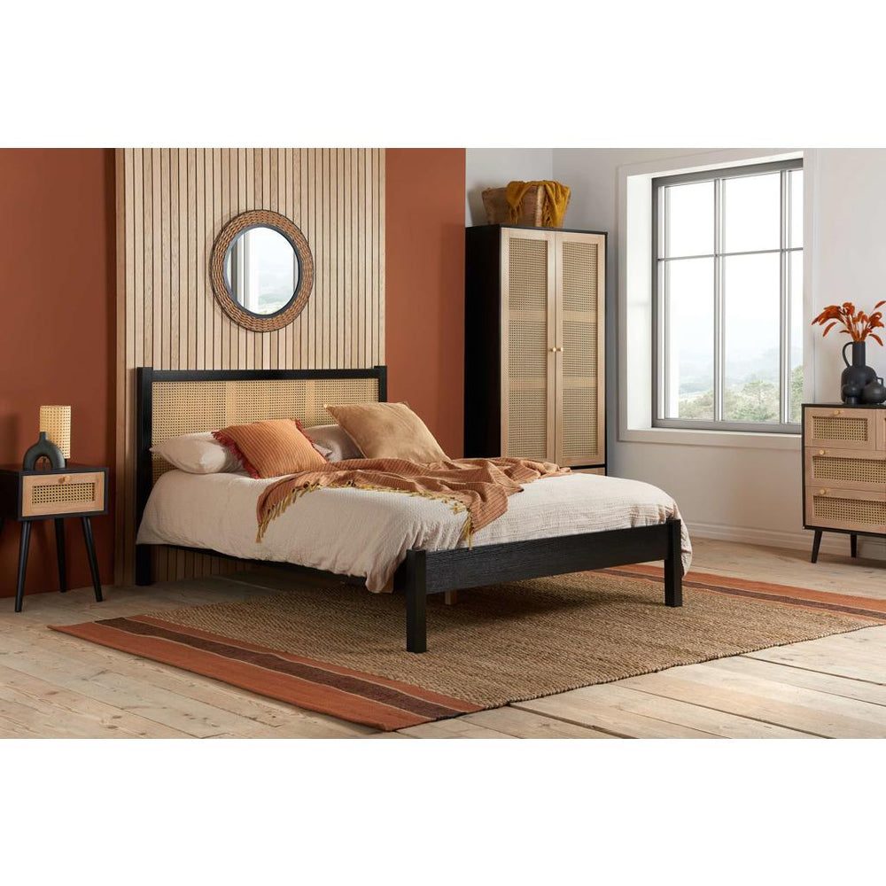 Bed with wooden headboard and mattress on a white background
