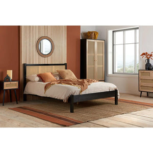 Bedroom with a bed, nightstands, and wardrobe.