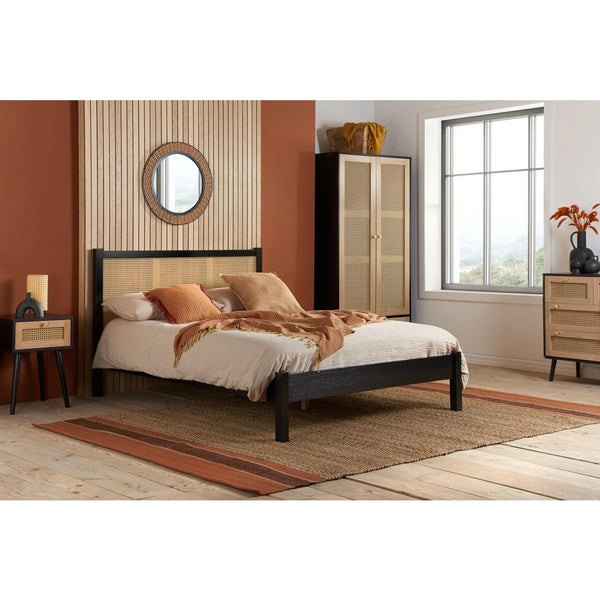 Bedroom with a bed, nightstands, and wardrobe.