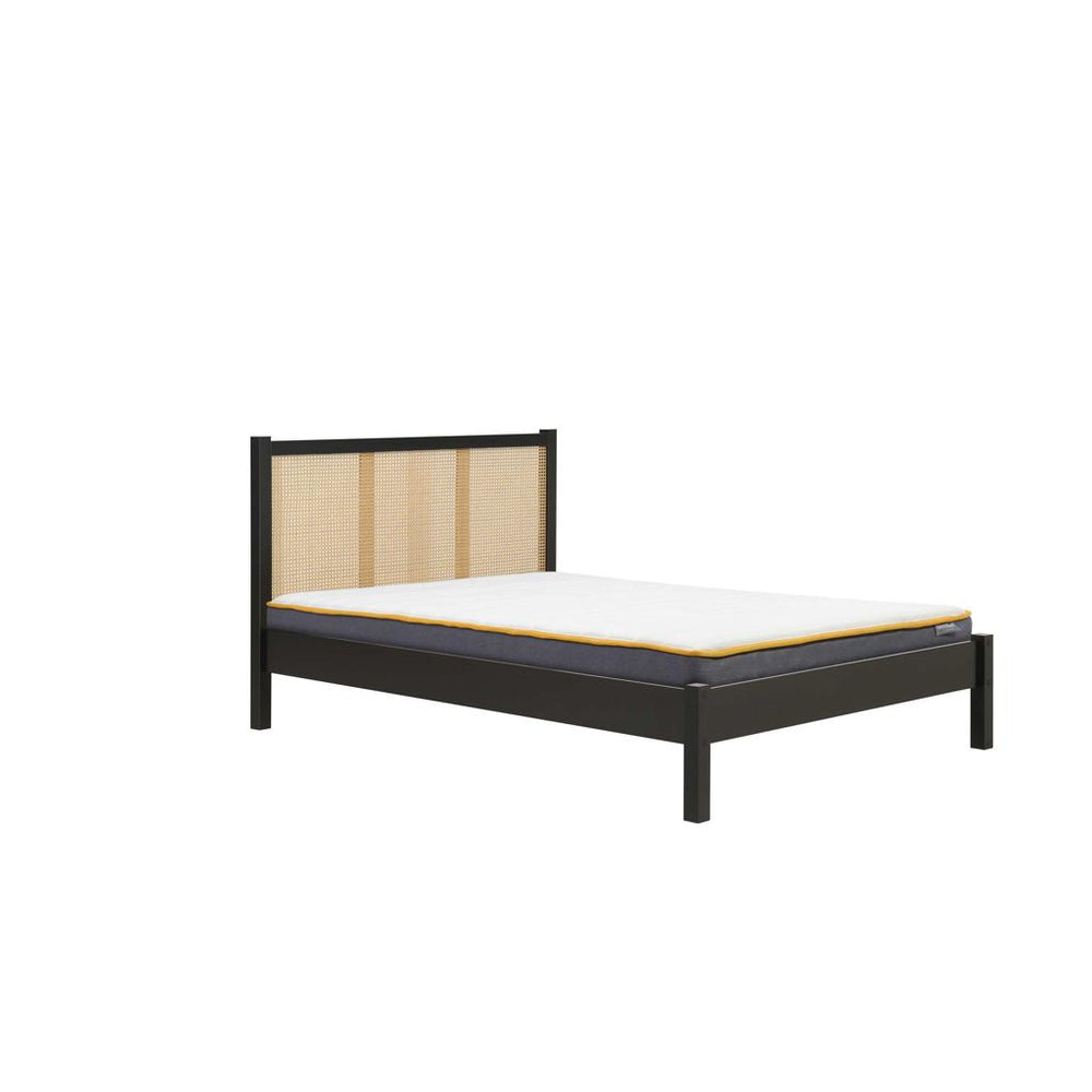 Bed with wooden headboard and mattress on a white background