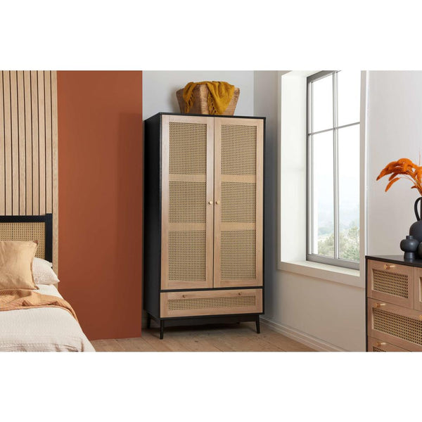 Wooden wardrobe with rattan style doors in a bedroom setting