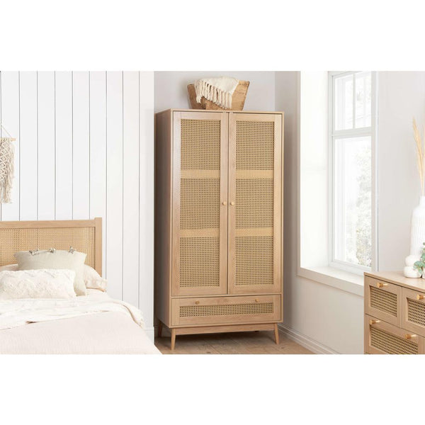 Wooden wardrobe with rattan-style doors in a bedroom setting