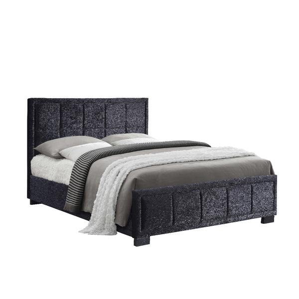Black upholstered bed with bedding on a white background