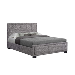 Gray upholstered bed with bedding on a white background