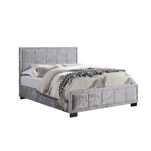 Gray upholstered bed with bedding on a white background