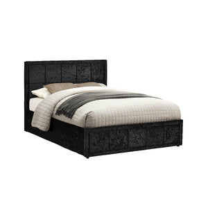 Black upholstered bed with white bedding on a white background