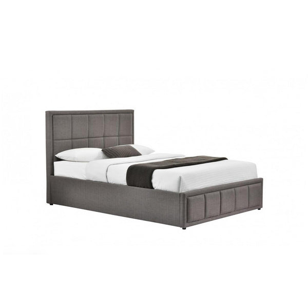Gray upholstered bed with white bedding on a white background