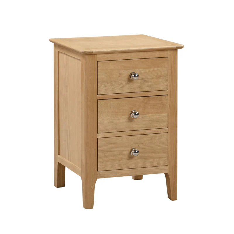 Wooden nightstand with three drawers on a white background
