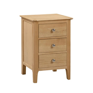 Wooden nightstand with three drawers on a white background