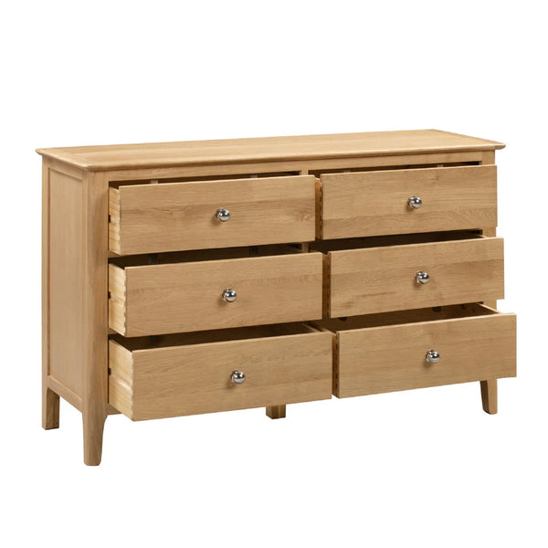 Wooden dresser with six drawers on a white background