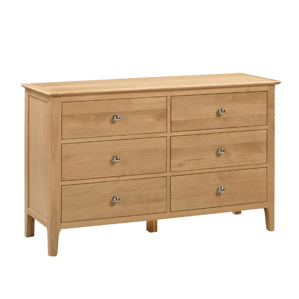 Wooden dresser with six drawers on a white background