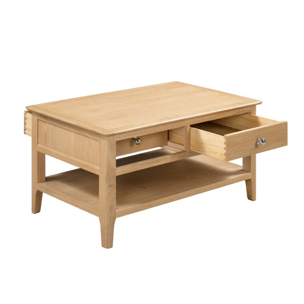 Wooden coffee table with two drawers on a white background