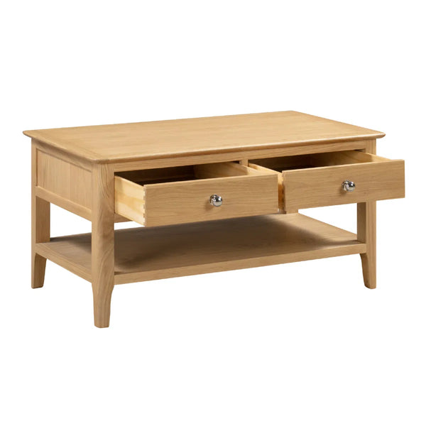 Wooden coffee table with two drawers on a white background