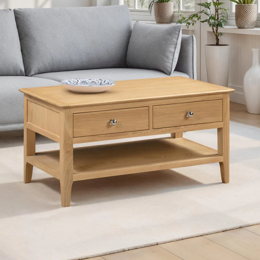 Wooden coffee table with two drawers on a white background