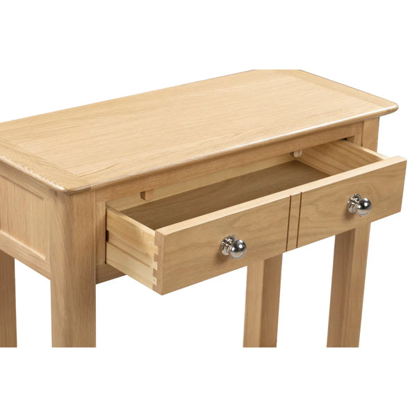 Wooden table with two drawers on a white background