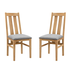 Two wooden chairs with gray cushions on a white background