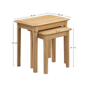 Two wooden nesting tables with dimensions labeled on a white background