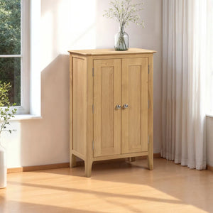 Wooden cabinet with two doors in a room with a window and curtains.