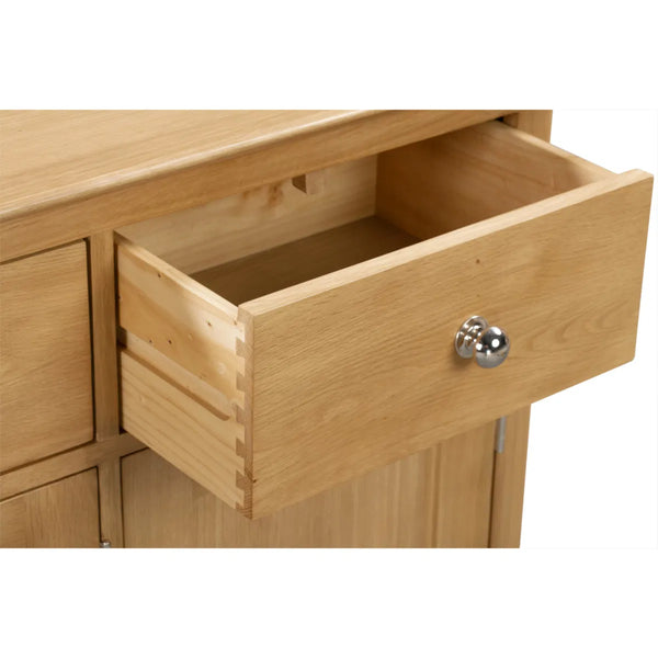 Wooden drawer with a silver handle on a white background