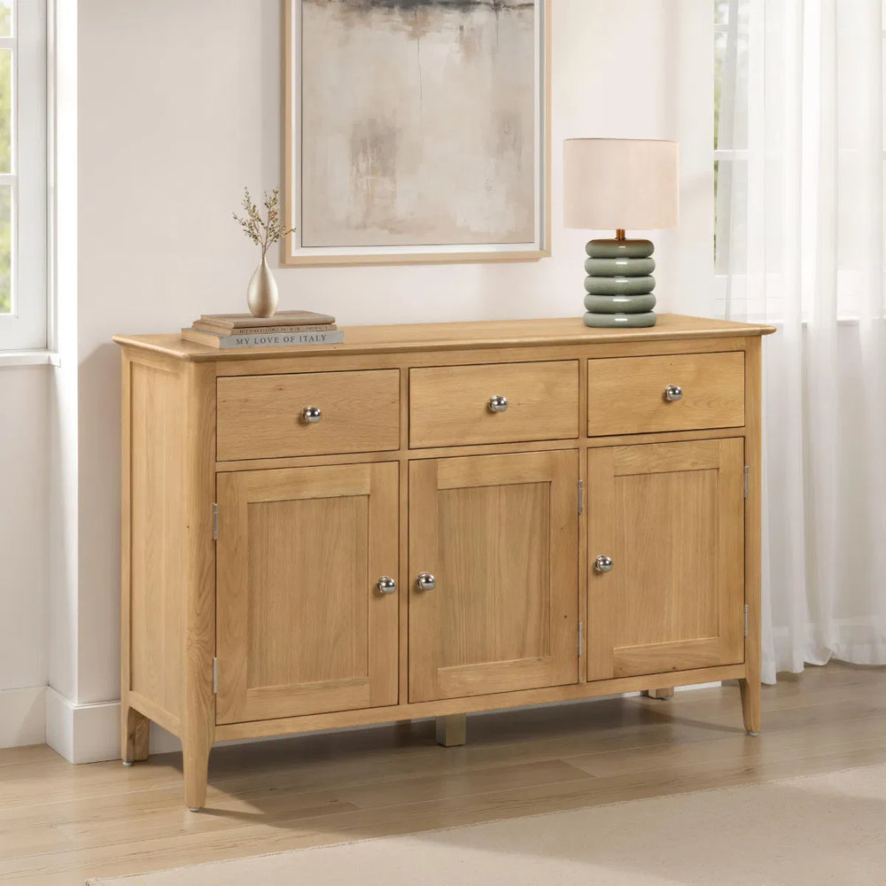 Wooden sideboard with three doors and three drawers on a white background