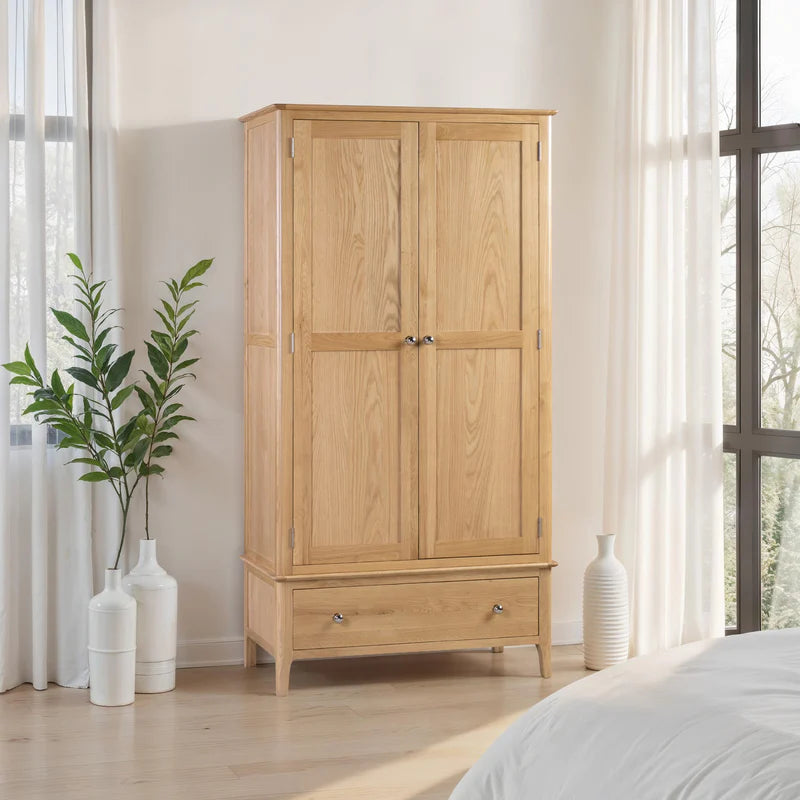 Wooden wardrobe with two doors and a drawer on a white background