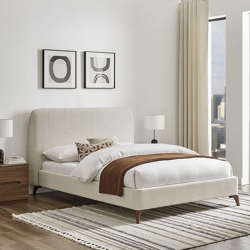 Beige upholstered bed with white mattress on a white background