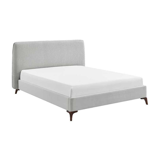 Gray upholstered bed with white mattress on a white background