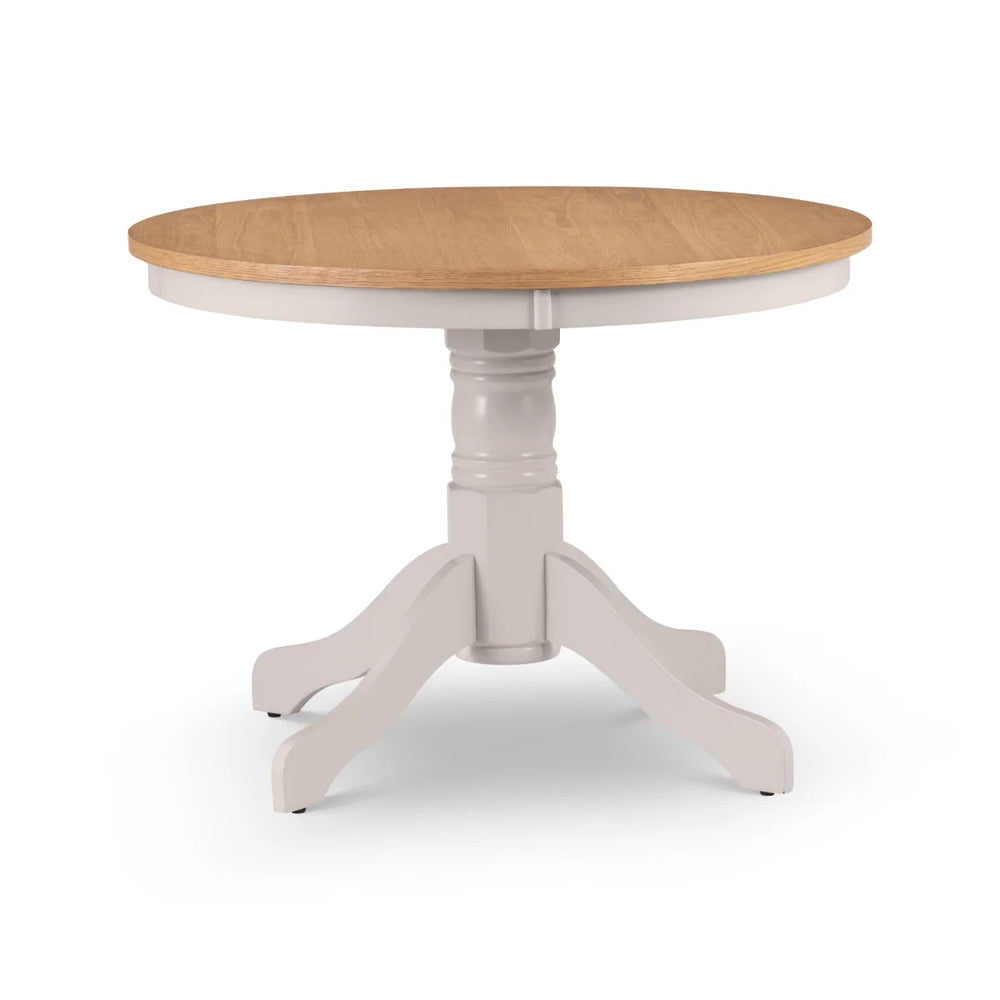 Round dining table with wooden top and white base on a white background