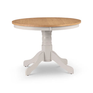 Round dining table with wooden top and white base on a white background