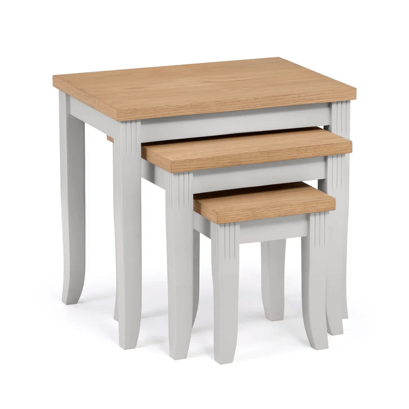 Set of three nesting tables with wooden tops and white bases on a white background