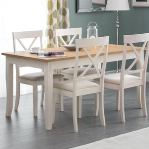 Dining room with a wooden table and white chairs on a gray floor.