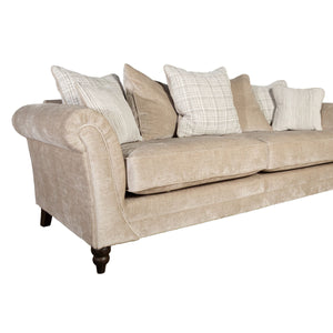 Beige sofa with patterned cushions on a white background