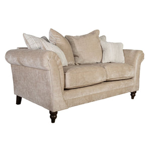 Beige sofa with decorative pillows on a white background