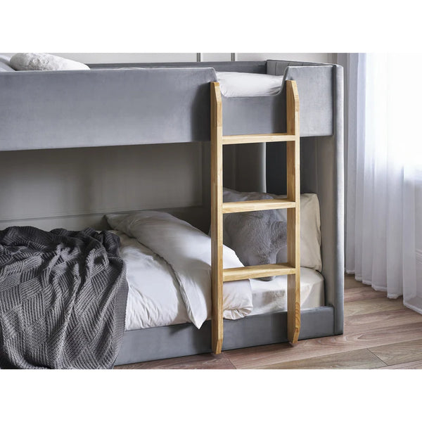 Bunk bed with gray bedsheets and a wooden ladder in a room.