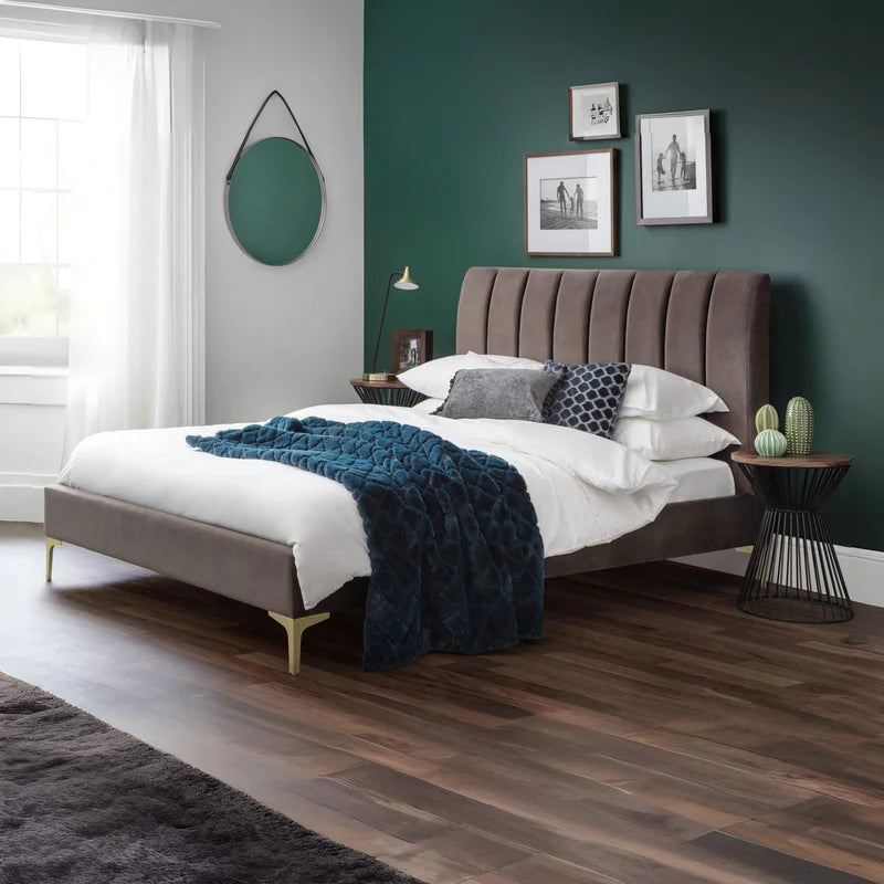 Bed with brown upholstered headboard and white bedding on a white background